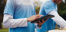 Volunteers using a tablet